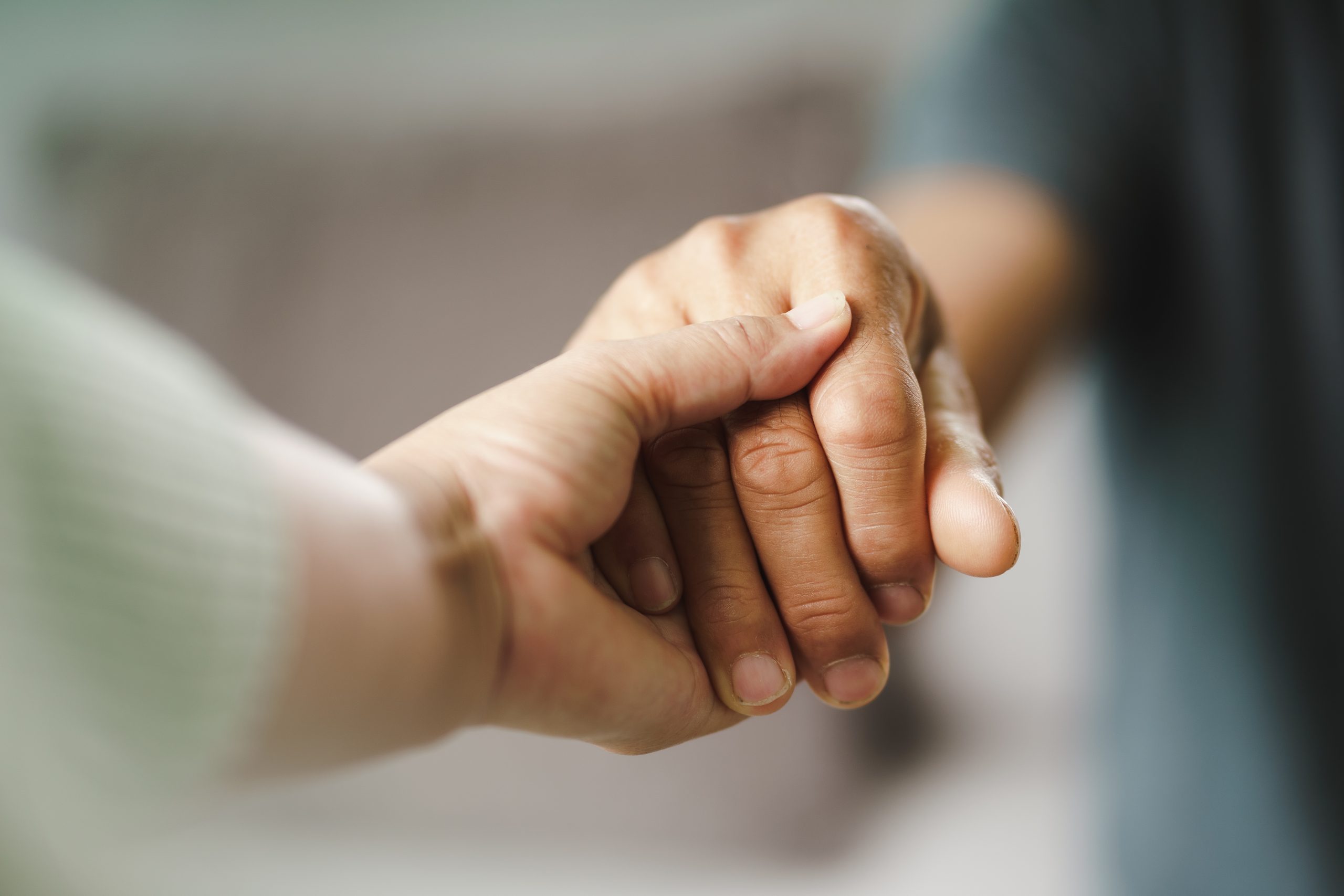 Female friend or family holding hands during cheer up to mental
