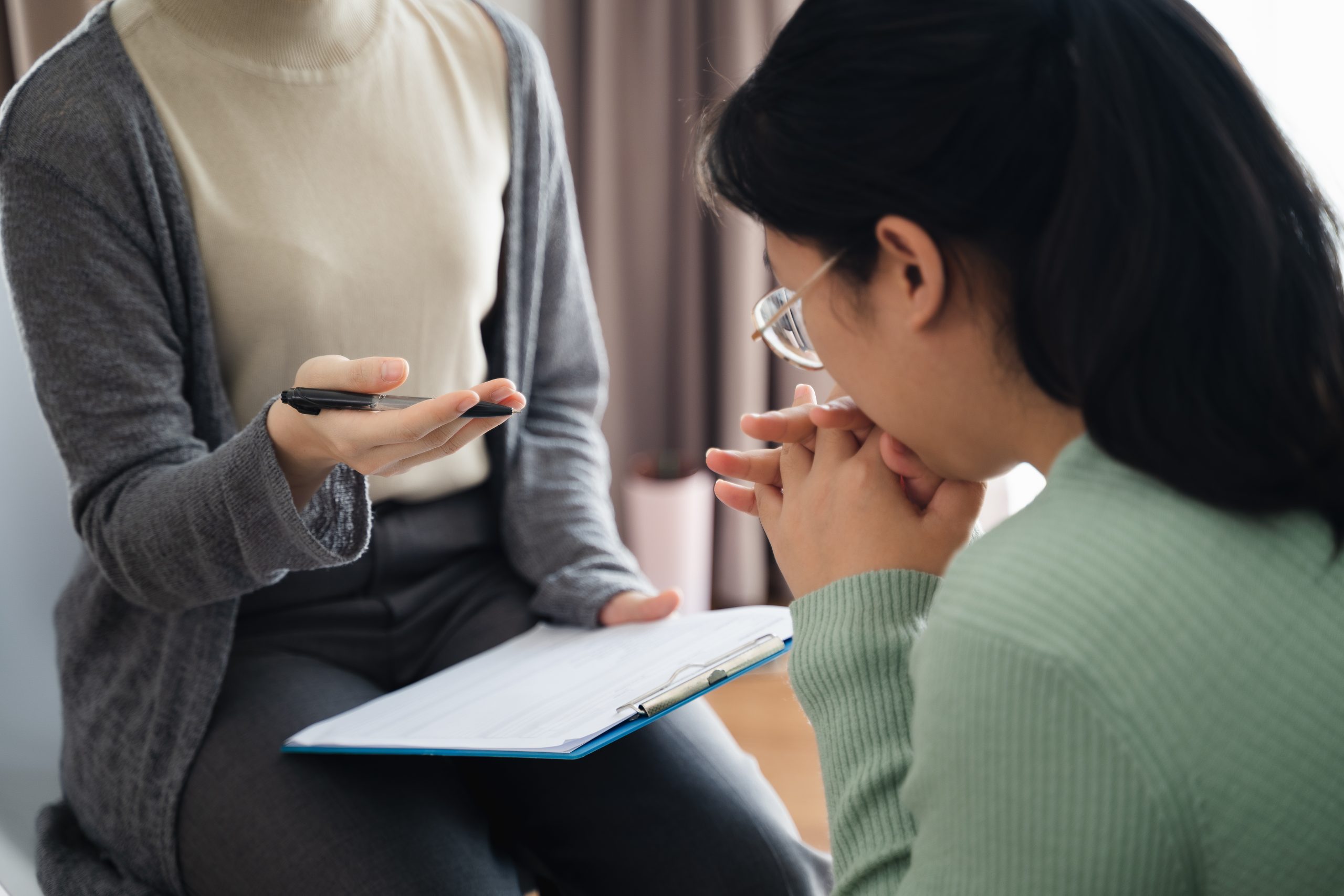Psychologist doctor examine and listen and talking to patient with depression, anxiety A compassionate counselling session in progress, showing a therapist gently engaging with a thoughtful client in a warm, private setting. Ideal representation of psychotherapy support available at Eleos Counselling in West Sussex, specialising in anxiety, relationship issues, and emotional wellbeing.