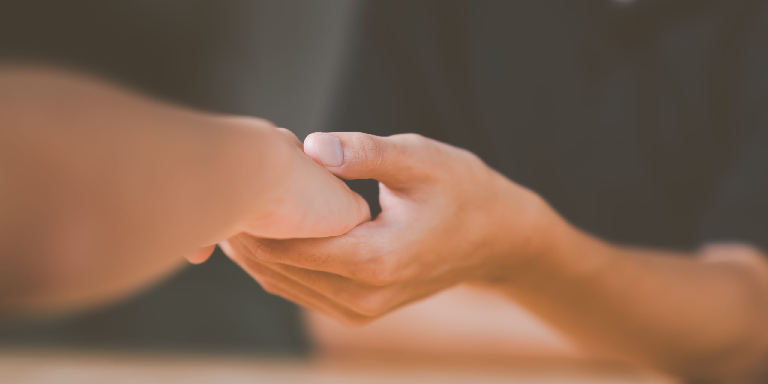 Husband and wife join hands to cheer ,Relationship care concept Couple holding hands in a therapy session – couples therapy near Midhurst, West Sussex with Eleos Counselling