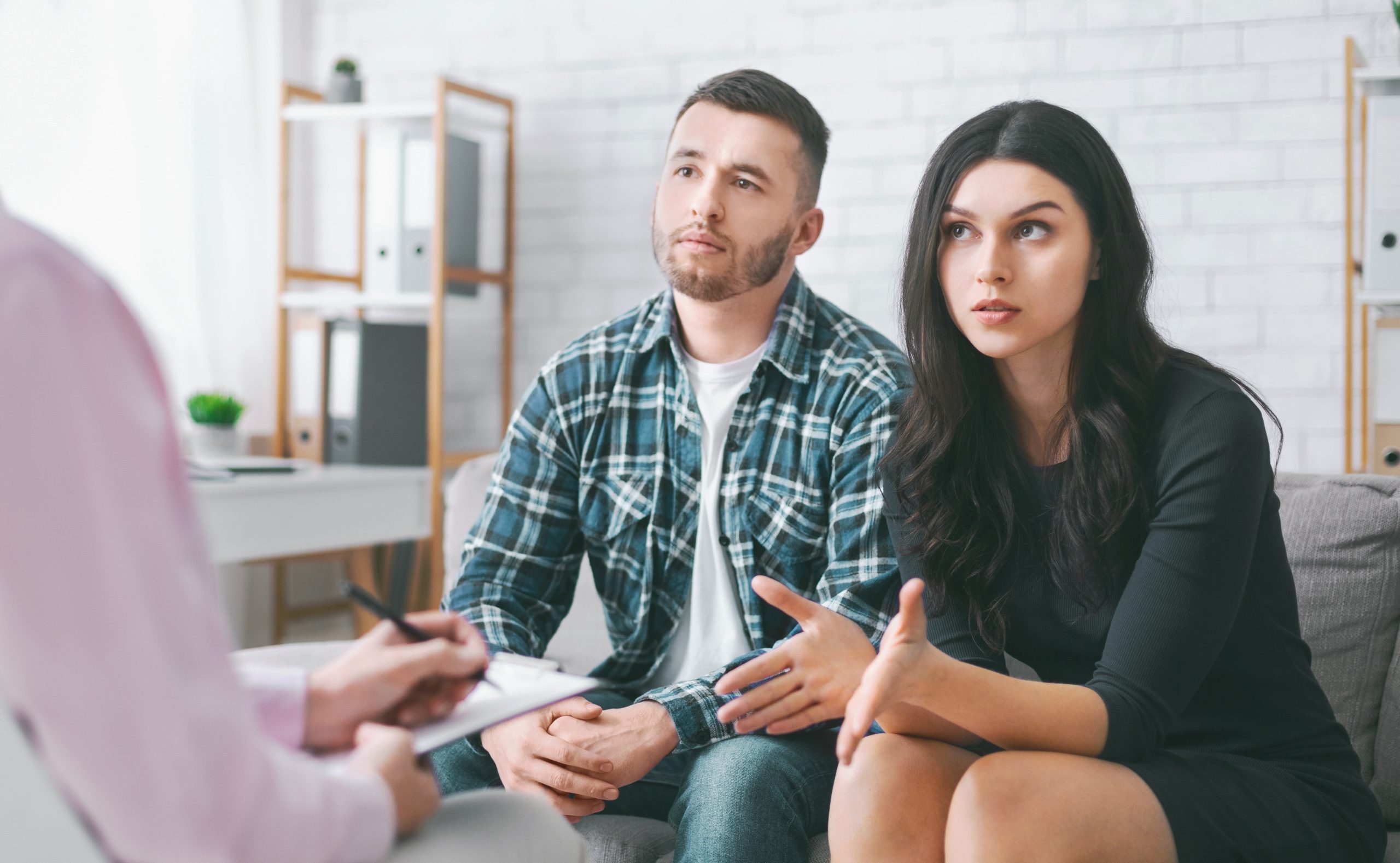 Young Couple Seeking Counseling During a Therapy Session A young couple sitting in in front of a therapist